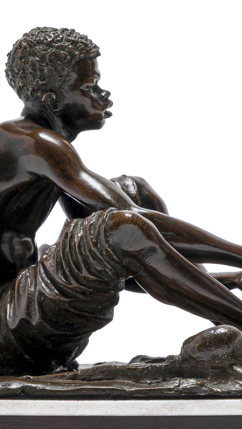 A statue of a man sitting on the ground. Description generated by AI