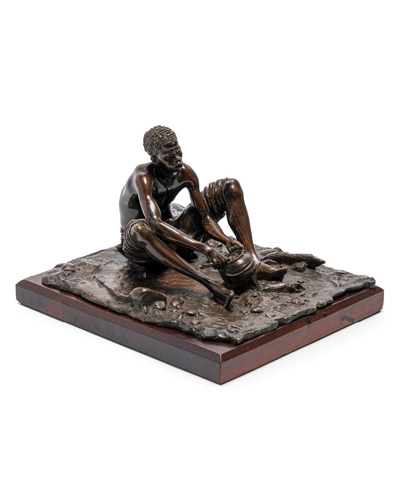 A statue of a man and woman sitting on a table. Description generated by AI