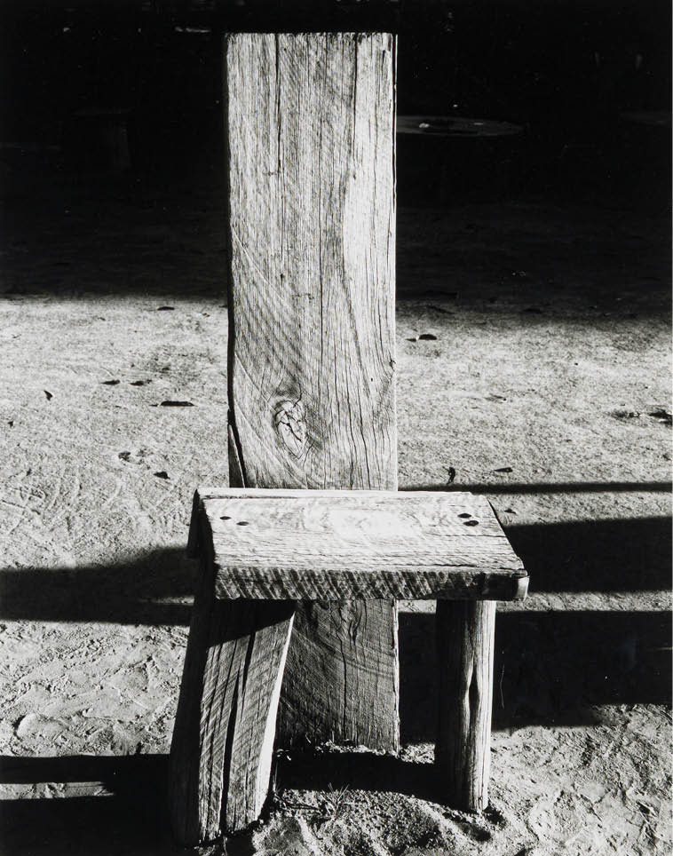 A wooden bench with a carved design. Description generated by AI