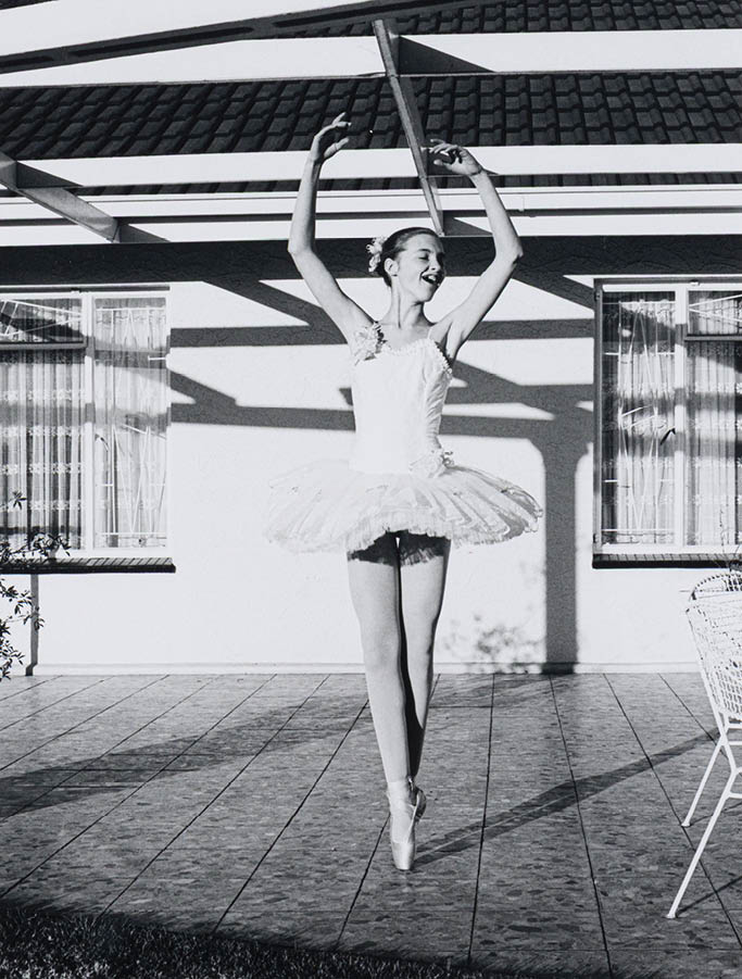 A woman is jumping in the air. Description generated by AI