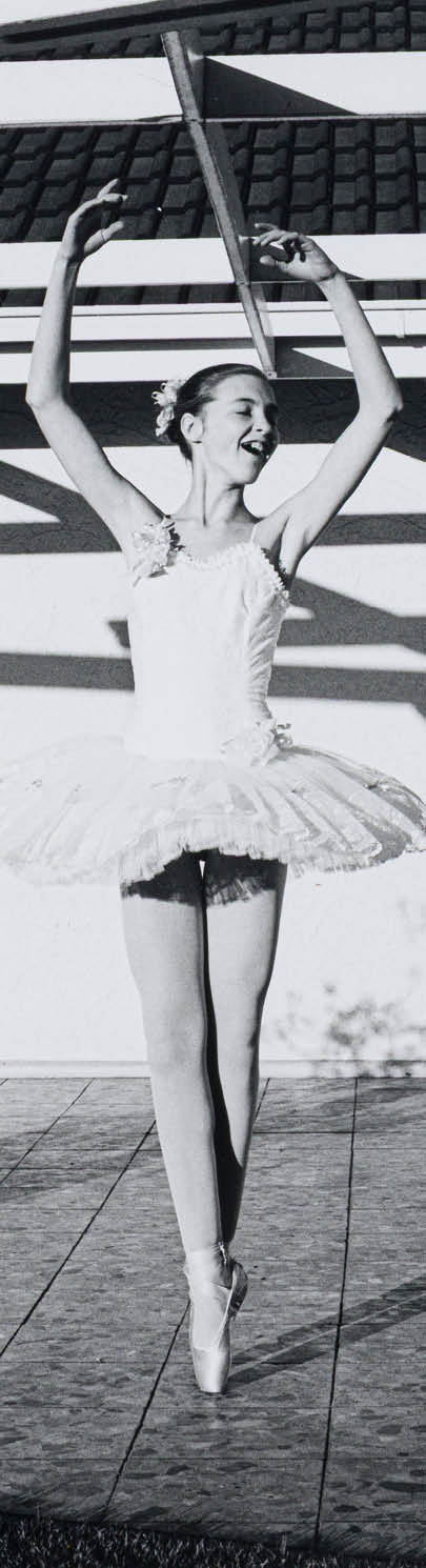 A woman is jumping in the air. Description generated by AI