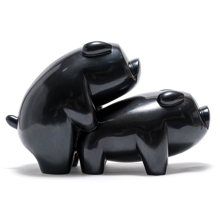 Two black bear statues are on a white background. Description generated by AI