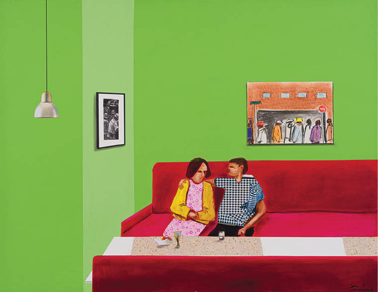 A man and woman sitting on a red couch. Description generated by AI