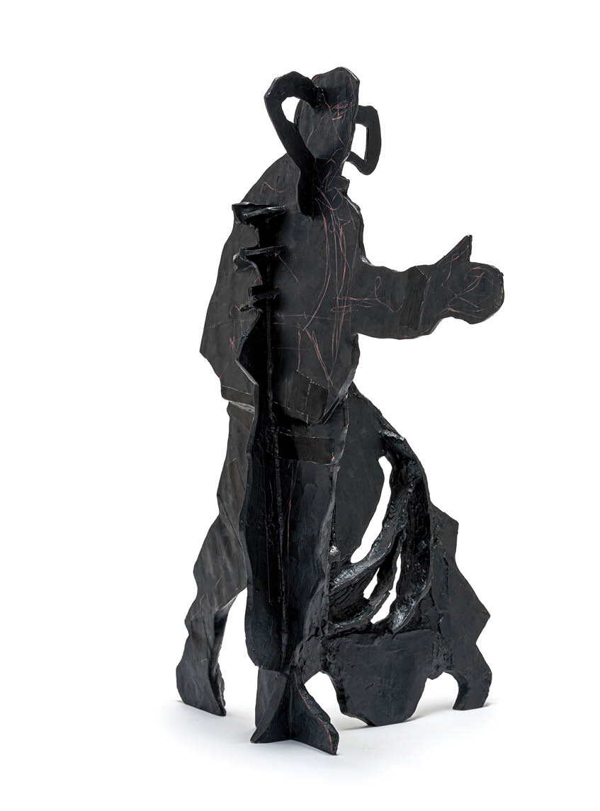 A statue of a man with horns and a pitchfork. Description generated by AI