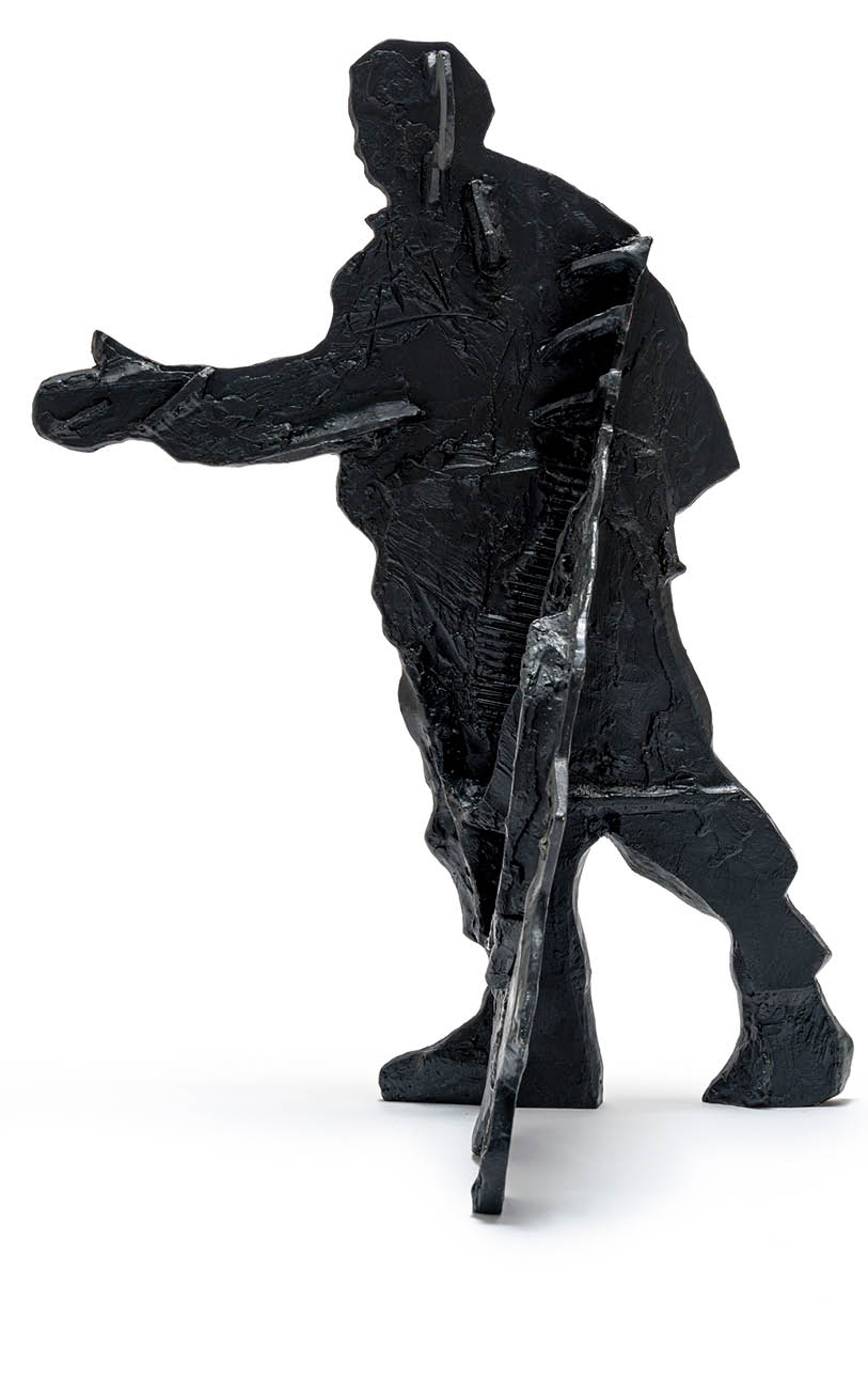 A statue of a man holding a cane. Description generated by AI