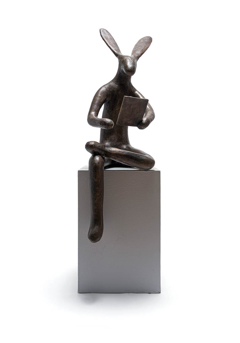 A statue of a rabbit sitting on a pedestal. Description generated by AI
