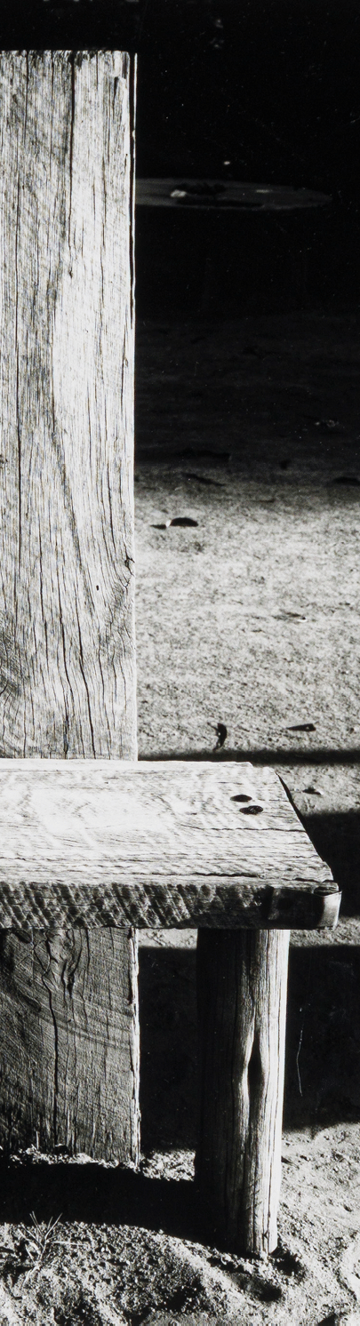 A wooden bench with a carved design. Description generated by AI