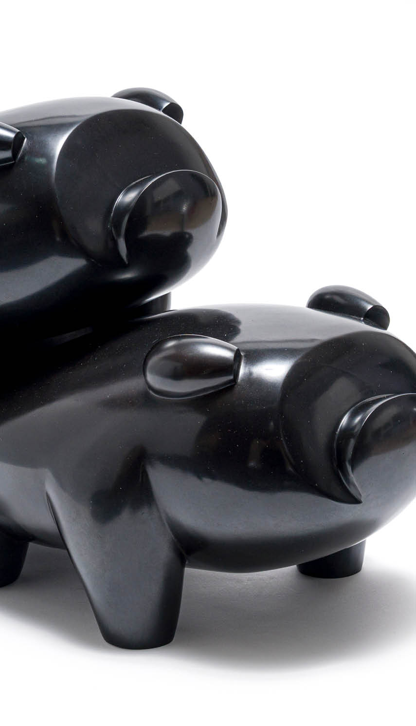 Two black bear statues are on a white background. Description generated by AI