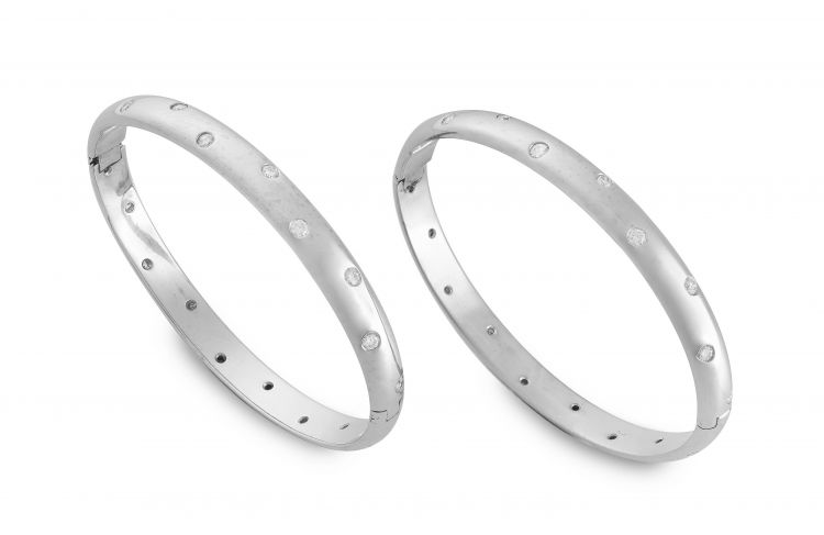 A pair of diamond and white gold bangles