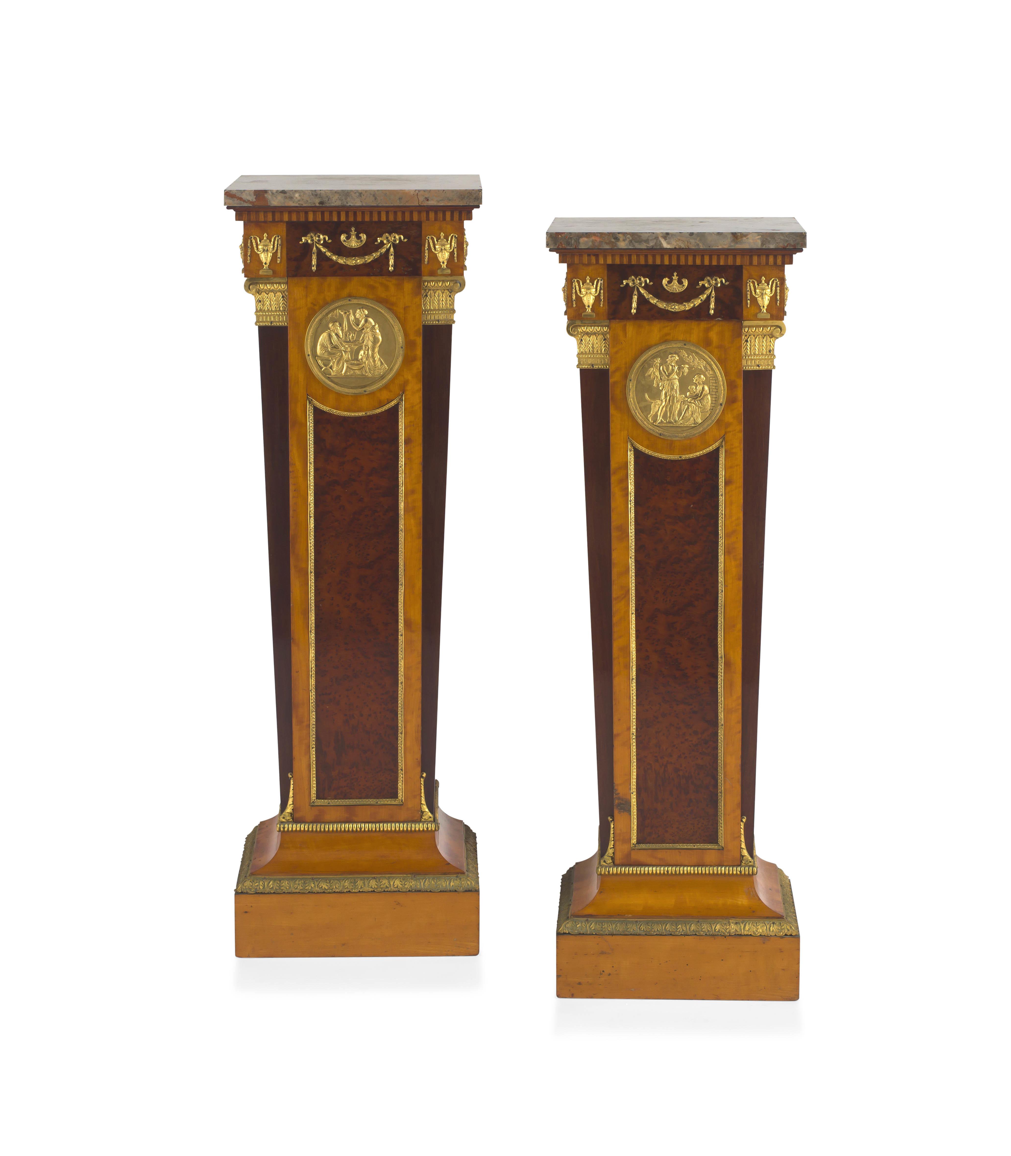 A pair of Empire style mahogany, birds-eye-maple and satinwood-veneered gilt-brass mounted pedestals, late 19th/early 20th century