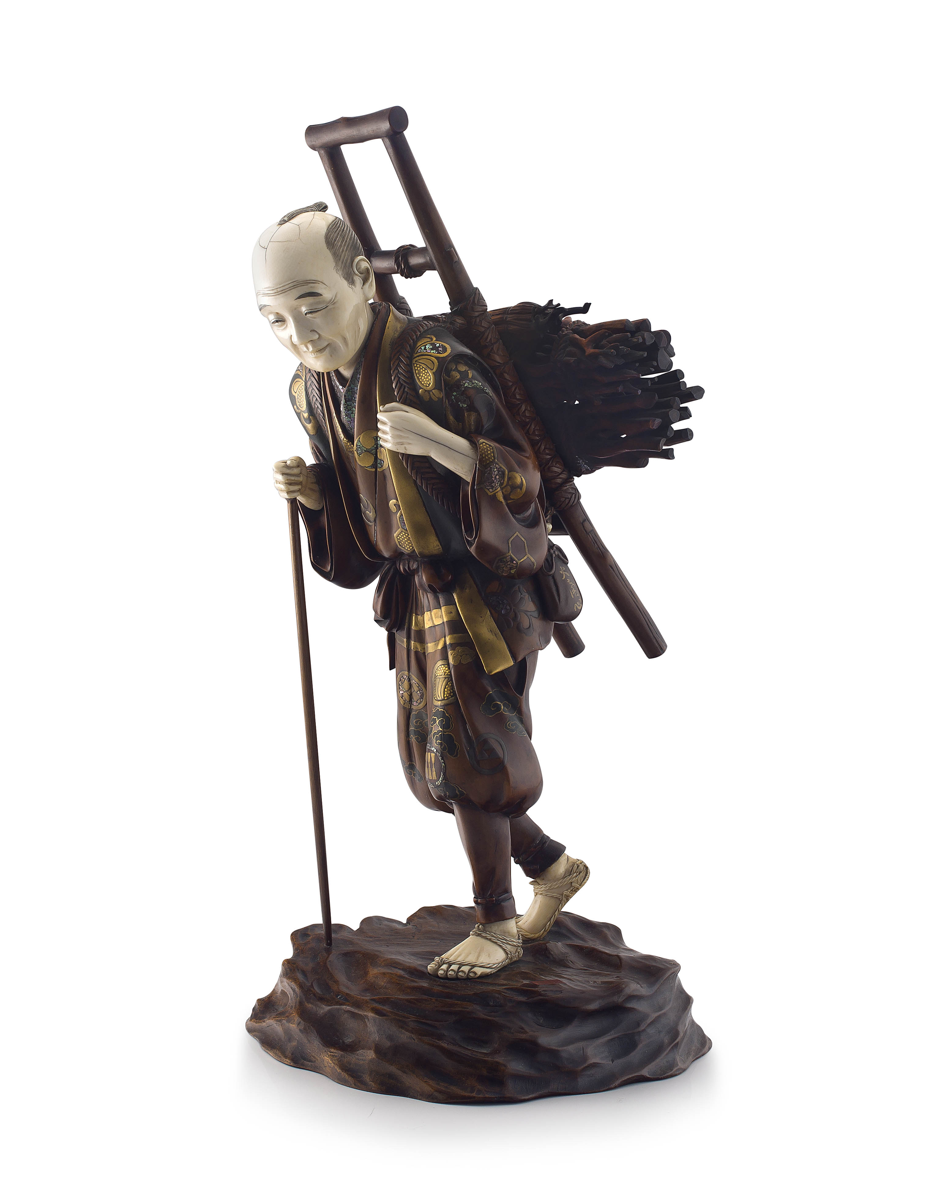 A large Japanese gold-lacquer and ivory figural okimono of a woodsman, Meiji period, 1868-1912
