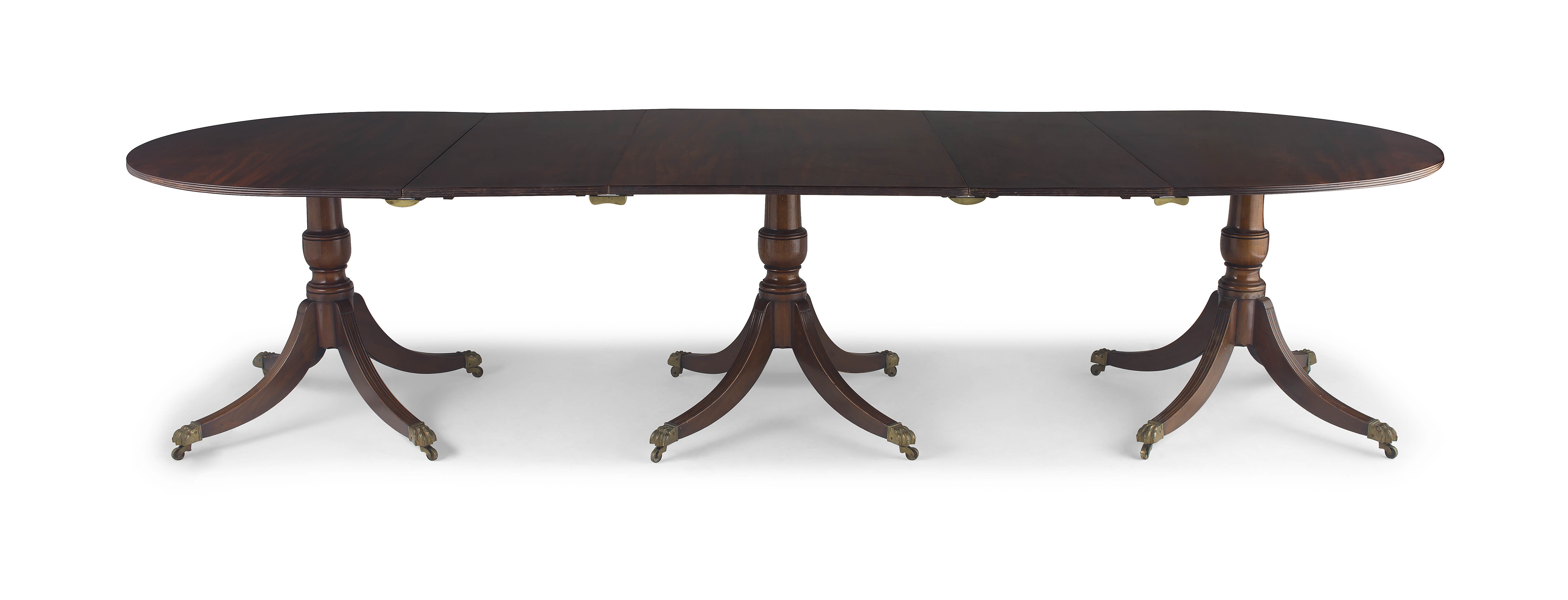 A George III style mahogany triple pedestal extending dining table