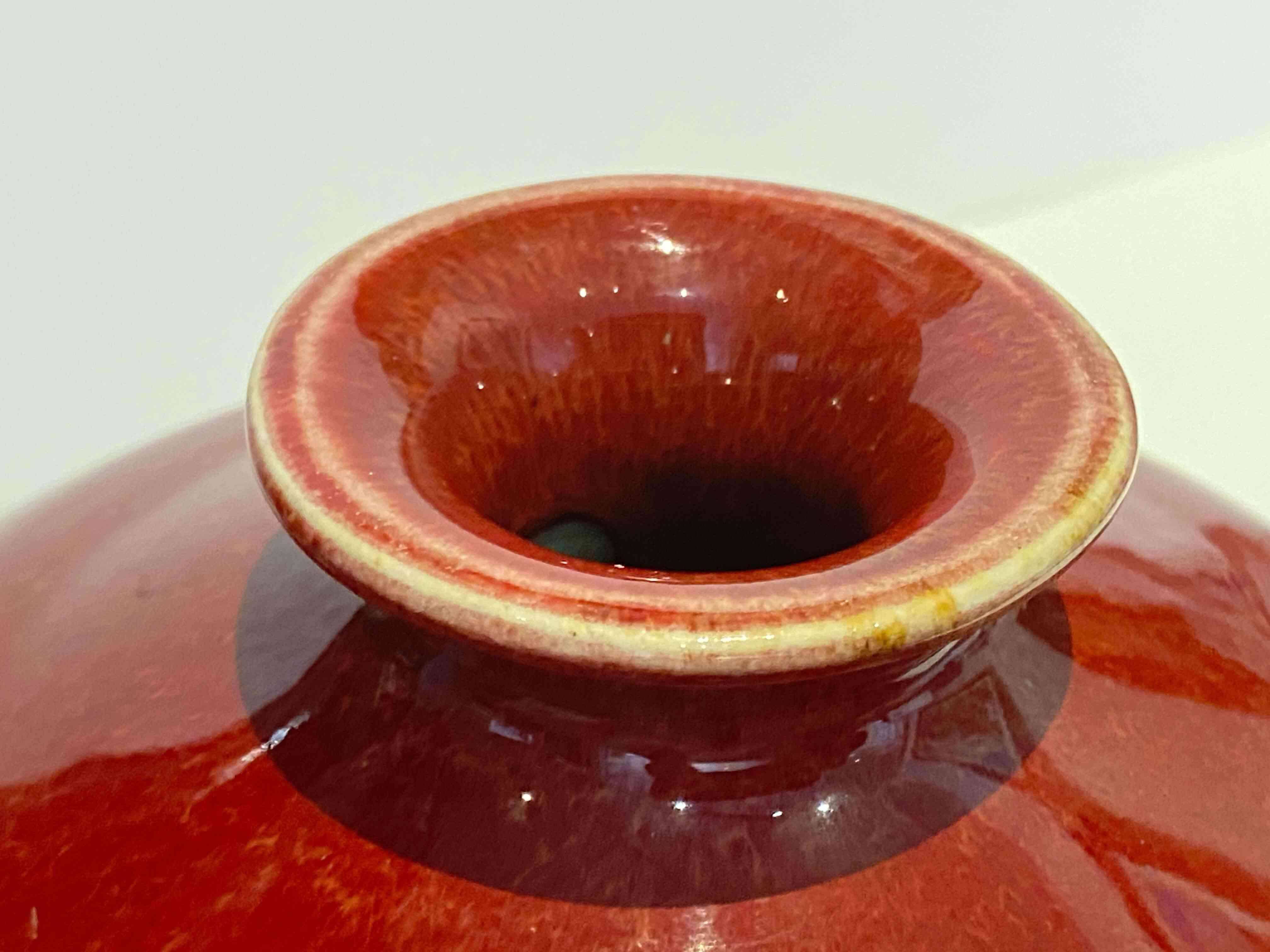 A Chinese red-glazed vase, Meiping, Qing Dynasty, 19th century