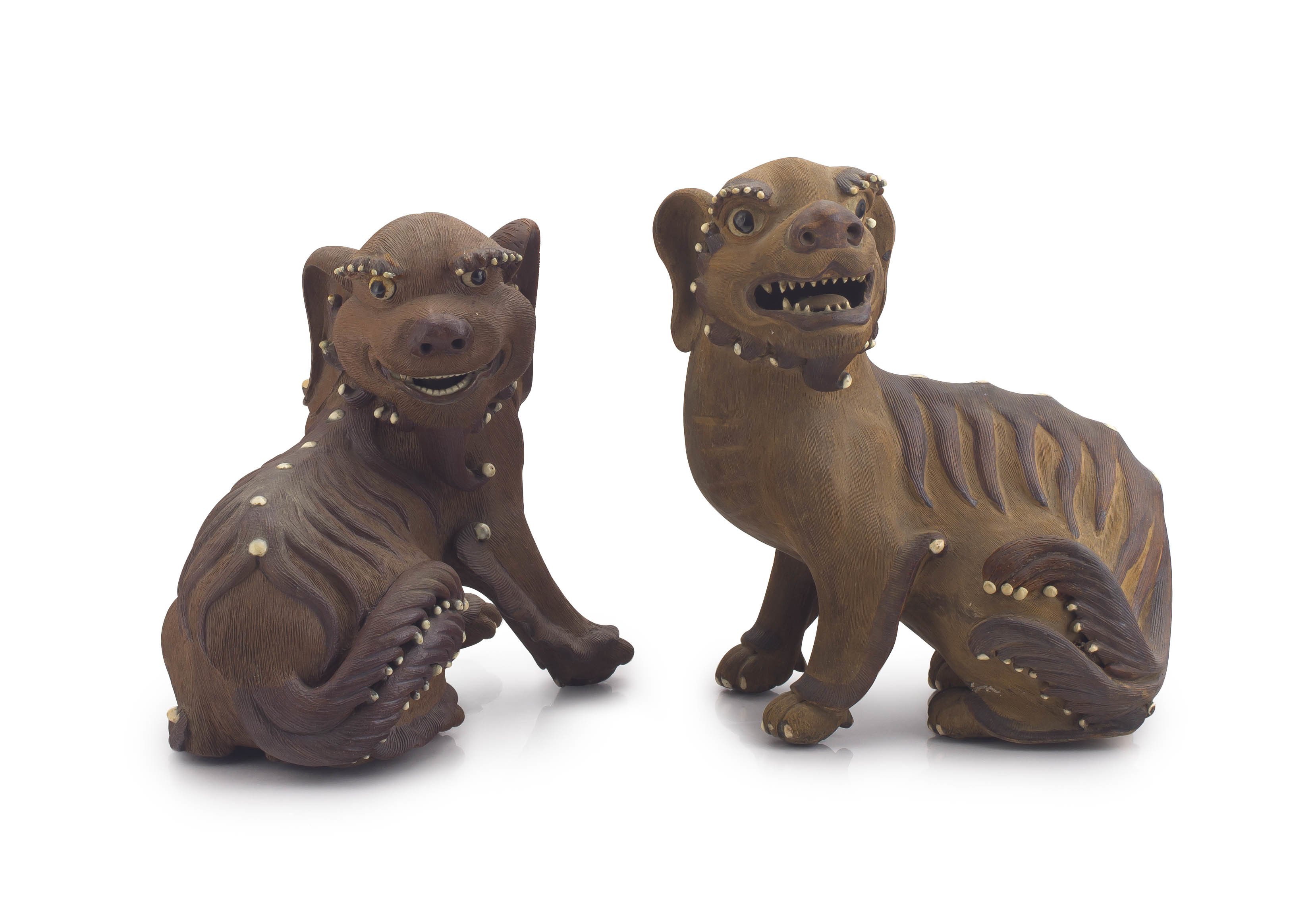 A pair of Chinese stoneware I-shing figures of fu lions, Qing Dynasty, 19th century