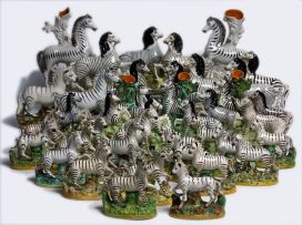 A collection of forty Staffordshire standing figures of zebras, 19th century