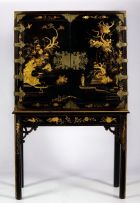 A black and gilt japanned cabinet on stand, 19th century and later