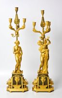A matched pair of neoclassical gilt-bronze and patinated bronze four-light candelabra, 19th century
