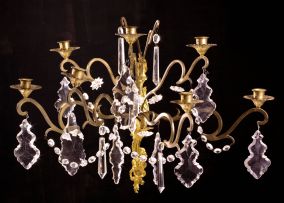 A set of four Louis XV style seven-light gilt-metal and brass wall sconces