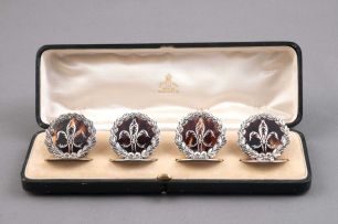 A cased set of four George V silver and tortoiseshell place card holders, William Comyns & Sons, Birmingham, 1913
