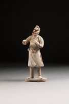 A Chinese painted pottery figure of a groomsman, Tang Dynasty