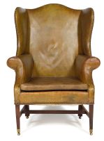 A George III style mahogany and close-nailed leather-upholstered wingback armchair