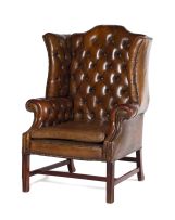 A George III style mahogany and close-nailed leather-upholstered wingback armchair