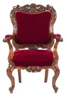 A Victorian rosewood and velvet-upholstered library armchair