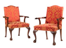 A pair of George I style upholstered and mahogany library armchairs