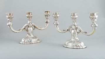 A pair of German silver three-light candlesticks, post 1884