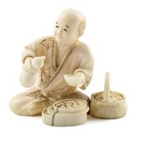 A Japanese ivory figure of clam seller, Meiji Period (1868-1912)