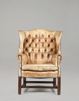 A George III style leather-upholstered close-nailed wing-back armchair, 20th century