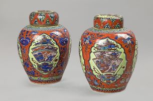 A pair of Chinese 'clobbered' jars and covers, 19th century