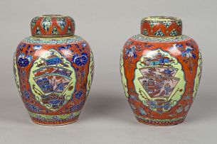 A pair of Chinese 'clobbered' jars and covers, 19th century