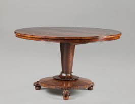 An early Victorian mahogany and rosewood circular tilt-top dining table