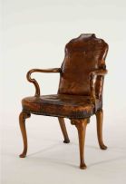 A George II style walnut and leather-upholstered armchair