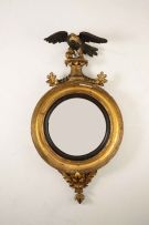 A Regency giltwood and ebonised convex mirror