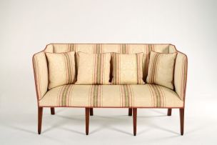 An Edwardian mahogany and upholstered settee