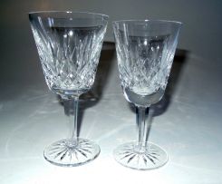 Waterford Crystal; A Set of Twelve Lismore Crystal Claret Glasses and an accompanying Twelve Lismore Crystal White Wine Glasses