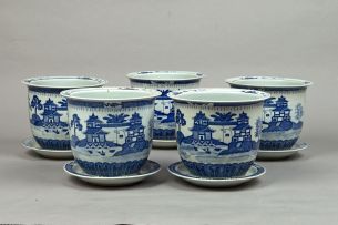 Five Chinese blue and white jardinières and stands, modern