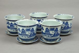 Five Chinese blue and white jardinières and stands, modern