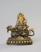 A gilt-bronze figure of Yellow Jambhala, Tibet, 18th/19th century