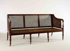A George III mahogany and caned settee