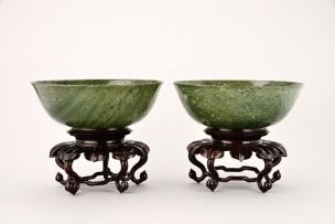 A pair of Chinese spinach jade bowls, Qing Dynasty, 19th century