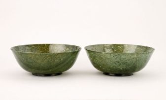 A pair of Chinese spinach jade bowls, Qing Dynasty, 19th century