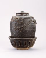 A Chinese brown-glazed pottery jar, cover and a basket, Song Dynasty (96-1279)