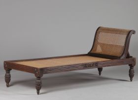 An Anglo Indian teak and caned day bed, 19th century