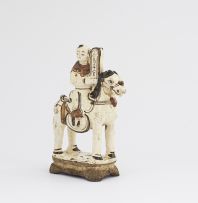 A Chinese Tz'u-chou type incense-holder in the form of a boy astride a pony, 17th century