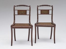 A pair of Regency mahogany and brass-inlaid side chairs