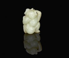 A Chinese carved pale celadon jade figure of a small boy, late 19th/early 20th century