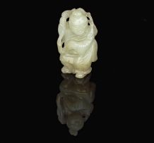 A Chinese carved celadon jade figure of a young boy, 20th century